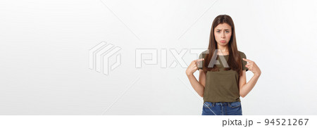 Beautiful young elegant woman over isolated background pointing hand and fingers with sad expression. 94521267