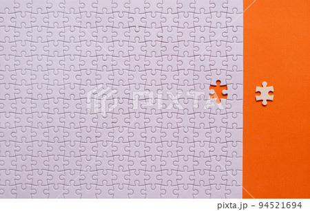 Jigsaw puzzle white color,Puzzle pieces grid,Success mosaic solution template,Horizontal on orange background copy space for text,Top view Jigsaw puzzle white color,Puzzle pieces grid,Success mosaic solution template,Horizontal on orange background copy space for text,Top view 94521694