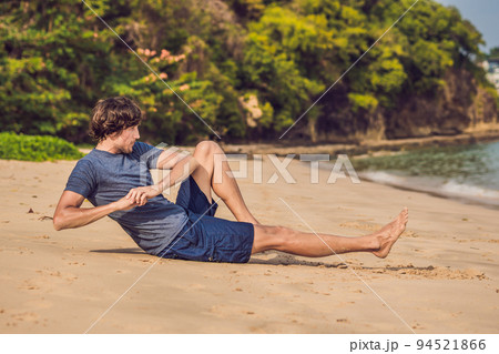 young male working out on beach, sporty man doing exercises young male working out on beach, sporty man doing exercises 94521866