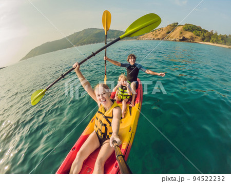 happy family with kid kayaking at tropical ocean happy family with kid kayaking at tropical ocean 94522232