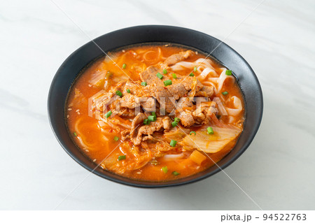 Korean udon ramen noodles with pork in kimchi soup 94522763