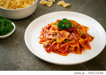 farfalle pasta in tomato sauce with parsley farfalle pasta in tomato sauce with parsley 94523209