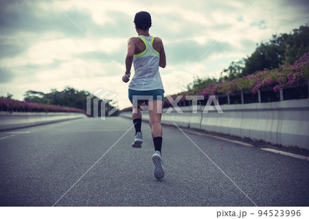 Fitness woman runner running on city bridge road Fitness woman runner running on city bridge road 94523996