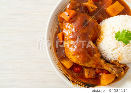 chicken stew with tomatoes, onions, carrot and potatoes on plate with rice chicken stew with tomatoes, onions, carrot and potatoes on plate with rice 94524114