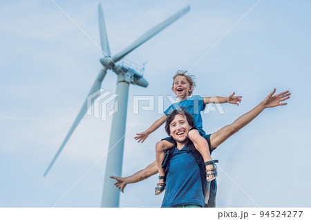 Father carrying son on shoulders and waving their arms like a windmill Father carrying son on shoulders and waving their arms like a windmill 94524277