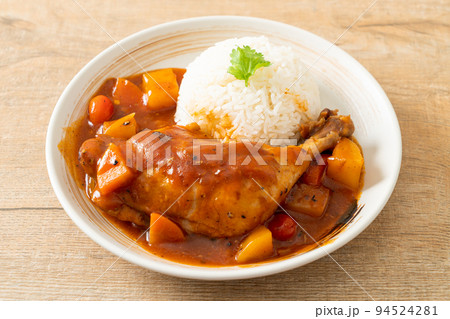 chicken stew with tomatoes, onions, carrot and potatoes on plate with rice chicken stew with tomatoes, onions, carrot and potatoes on plate with rice 94524281