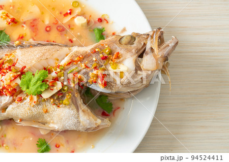 Steamed grouper fish with lime and chillies 94524411