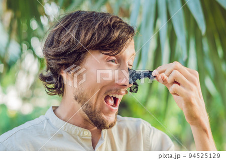 Happy man with black mask on the face. Photo of man receiving spa treatments. Beauty Skin care concept 94525129