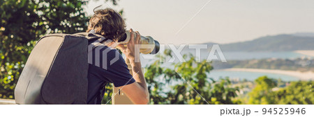 BUNNER man looks in Coin-operated binoculars at the sea 94525946