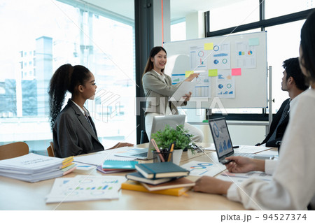 diverse business team people and female leader boss discuss financial result review paperwork share ideas brainstorm collaborate work in teamwork at group briefing table 94527374