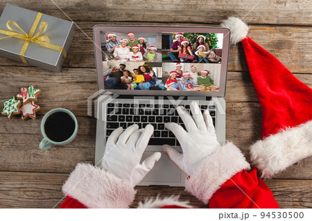 Santa claus on christmas laptop video call with diverse group of friends 94530500