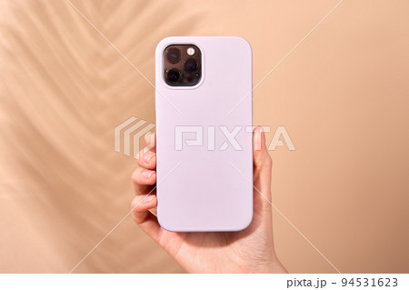 Hands holding a smartphone in a case 94531623
