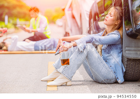 women teen drunk drink alcohol during drive a car accident at roadside sitting sleep unconscious 94534550