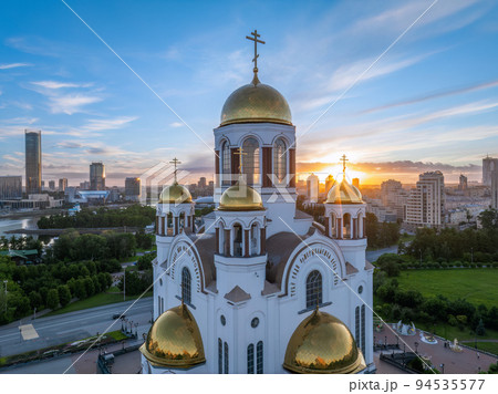 Summer Yekaterinburg and Temple on Blood in cloudy sunset. Aerial view of Yekaterinburg, Russia. Translation of the text on the temple 94535577