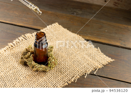 Image of cbd oil in bottle on wooden background 94536120