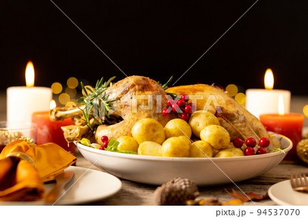 Thanksgiving table with roast turkey, potatoes, candles and autumn decoration 94537070