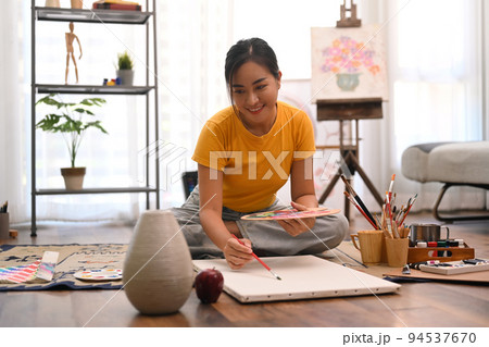 Peaceful female artist painting picture on canvas with oil paints. Leisure activity, creative hobby and art concept 94537670