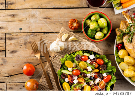 Overhead view of thanksgiving table roast turkey, vegetables autumn decoration copy space on wood 94538787