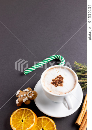 Image of cup of cappuccino coffee and christmas gingerbread man with copy space on grey 94539134
