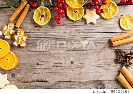 Image of gingerbread man cinnamon sticks and christmas decoration with copy space on wood Image of gingerbread man cinnamon sticks and christmas decoration with copy space on wood 94539165