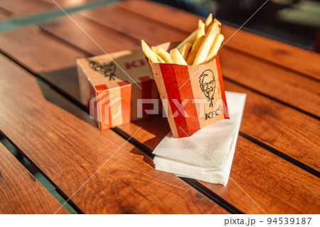 Krakow, Poland - September 11 2022: KFC fast food Fried Chicken (also known as Kentucky Fried Chicken) small box ready to serve to customer, KFC is a famous fast food restaurant chain. Krakow, Poland - September 11 2022: KFC fast food Fried Chicken (also known as Kentucky Fried Chicken) small box ready to serve to customer, KFC is a famous fast food restaurant chain. 94539187