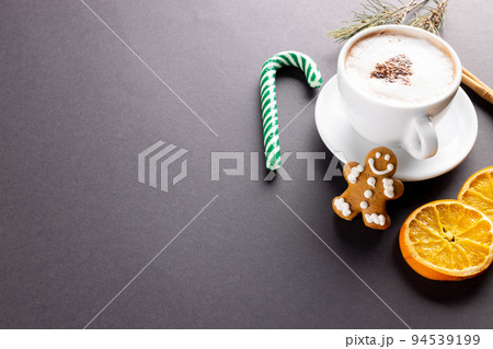 Image of cup of cappuccino coffee and christmas gingerbread man with copy space on grey 94539199