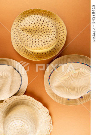 Vertical image of straw hats on yellow surface 94539418