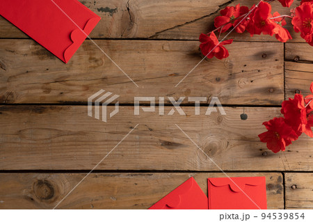 Composition of red flowers and envelopes on wooden background 94539854