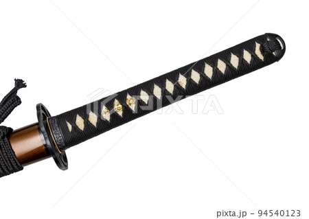 Tsuka - handle of Japanese sword wrapped by black silk cord on white ray skin isolated in white background. Selective focus. Tsuka - handle of Japanese sword wrapped by black silk cord on white ray skin isolated in white background. Selective focus. 94540123