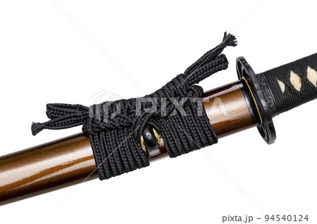Black color Sageo - Japanese sword sheath rope made of high quality silk isolated on white background. Selective focus. Black color Sageo - Japanese sword sheath rope made of high quality silk isolated on white background. Selective focus. 94540124