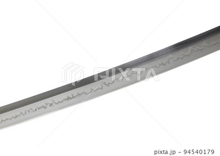 Japanese sword blade on white background. Soft focus.  The wavy pattern on the blade edge is a line of hardness that a blacksmith makes so that the blade doesn't break. Choji Hamon style. 94540179