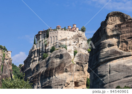 Rising high above the Thessalian plain, the sandstone megalith on which the Varlaam monastery 94540901
