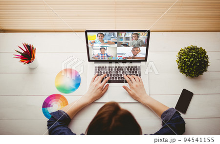 Caucasian woman using laptop for video call, with smiling diverse high school pupils on screen Caucasian woman using laptop for video call, with smiling diverse high school pupils on screen 94541155
