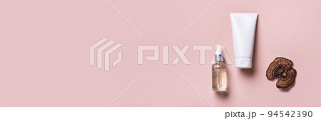 Cosmetic beauty products with mushrooms on pink banner. Mushroom skincare concept Cosmetic beauty products with mushrooms on pink banner. Mushroom skincare concept 94542390