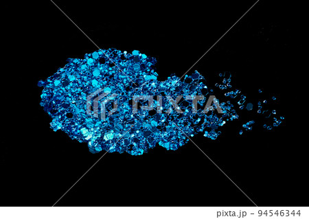Blue glitter makeup product smear on black. Eye shadow, lip gloss and face for holiday makeup swatch 94546344