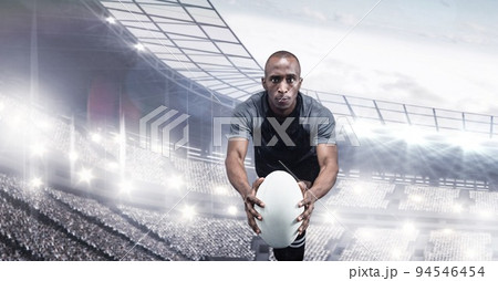 Composition of male rugby player holding rugby ball over sports stadium Composition of male rugby player holding rugby ball over sports stadium 94546454