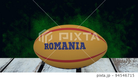 Composition of rugby ball decorated with text romania on black background 94546715