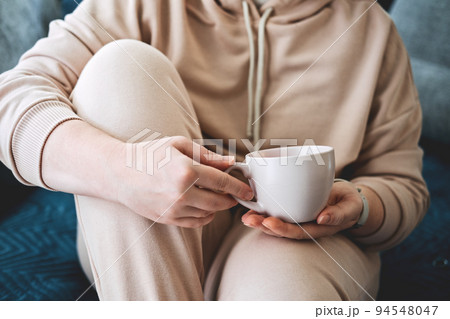 Self care, staying home, cozy mood. Take care of yourself, Love yourself concept. Woman hands with cup of hot drink at home 94548047