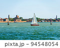 White and Red Sailing Boat in the Venetian Lagoon - Venice Veneto Italy 94548054