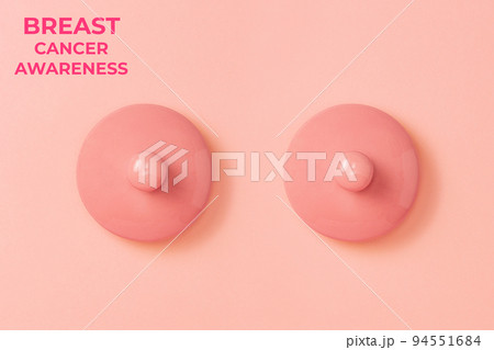 Two pink ceramic lids on a pink background symbolizing the female breast. Flat lay. Concept of Breast Cancer Awareness Month Two pink ceramic lids on a pink background symbolizing the female breast. Flat lay. Concept of Breast Cancer Awareness Month 94551684