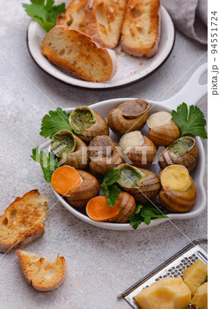Baked snails Escargot with bread Baked snails Escargot with bread 94551724