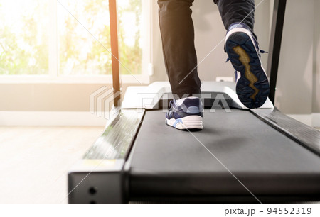 back view of male Legs cardio running on the treadmill at fitness gym. Close up with copy space. back view of male Legs cardio running on the treadmill at fitness gym. Close up with copy space. 94552319