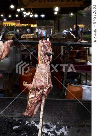View of the preparation of a pig on a restaurant grill 94552603