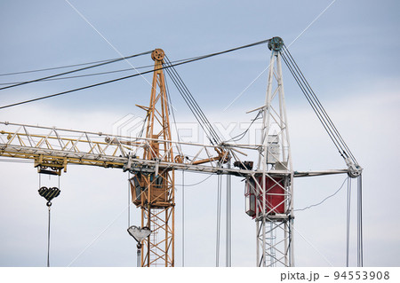 Tower cranes at high residential apartment buildings construction site. Real estate development 94553908