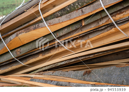 Stack od wooden boards prepared for cutting by chainsar for firewood. Stack od wooden boards prepared for cutting by chainsar for firewood. 94553939