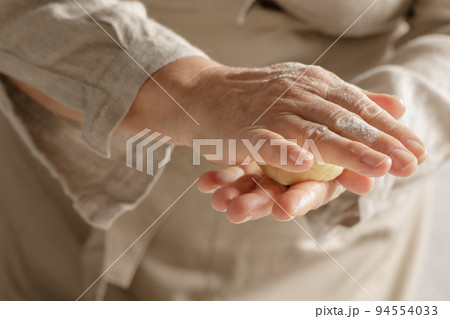 Womens hands, flour and dough. A woman is preparing a dough for home baking. Concept of home cooking with organic and natural ingredients. Zero waste concept 94554033