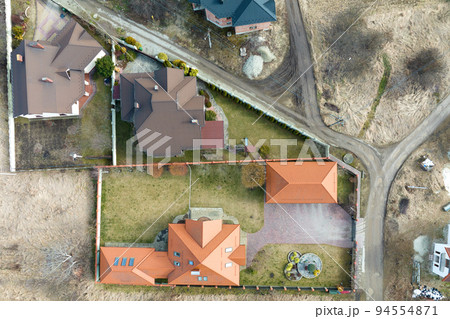 Aerial view of residential house with backyard in suburban rural area 94554871