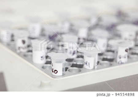Closeup of test tubes at a thermal cycler block in a molecular biology laboratory. Polymerase chain reaction technique. PCR technique 94554898