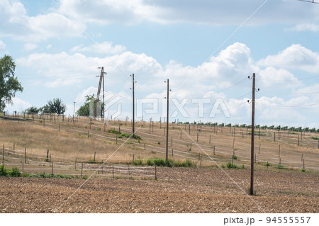 Older wooden overhead power transmission line across the landscape 94555557