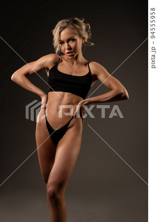 Alluring woman in black underwear standing on dark backgorund 94555958